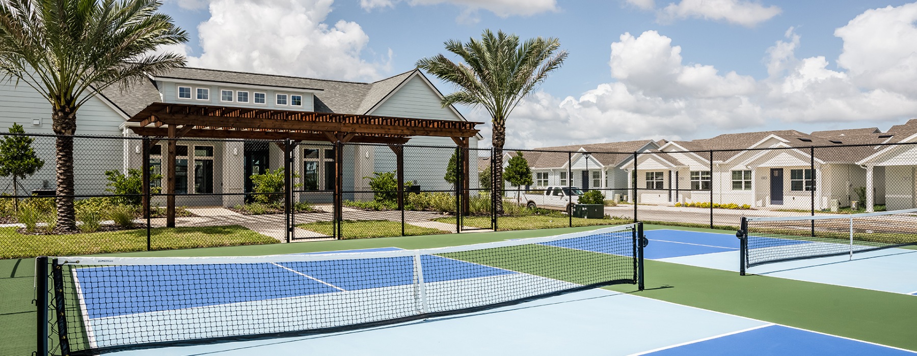 Fenced in pickleball courts next the the clubhouse at Abrazo at Four Corners pet-friendly homes for rent in Kissimmee Florida.
