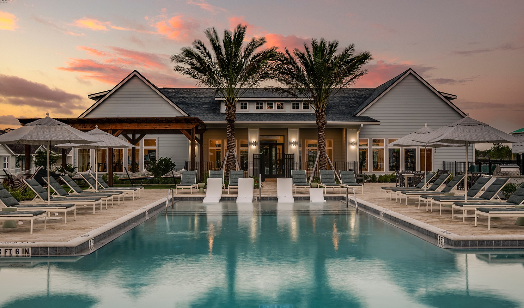 pool area with reclining seats and landscaping